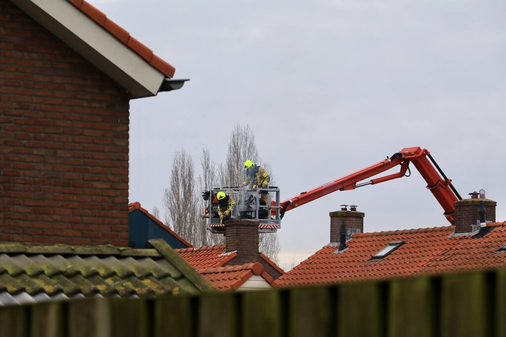 Brandweer blust brand in schoorsteen