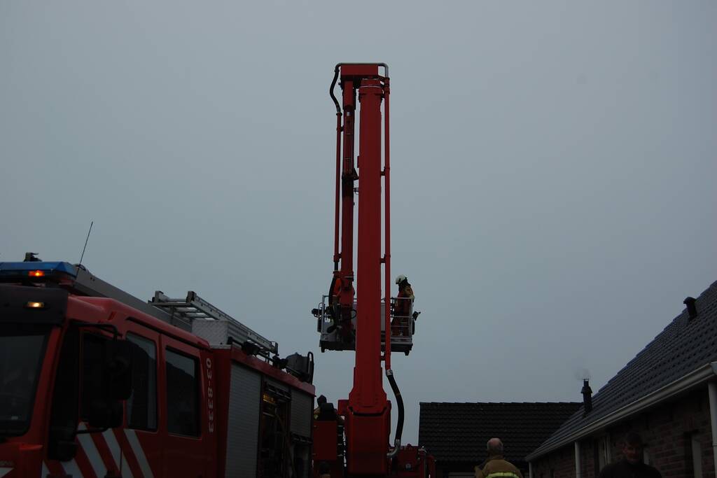 Brandweer blust brand in schoorsteen