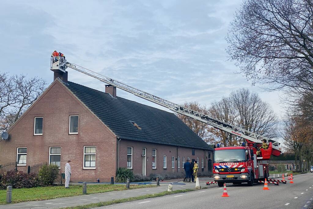 Brandweer veegt schoorsteen na brand