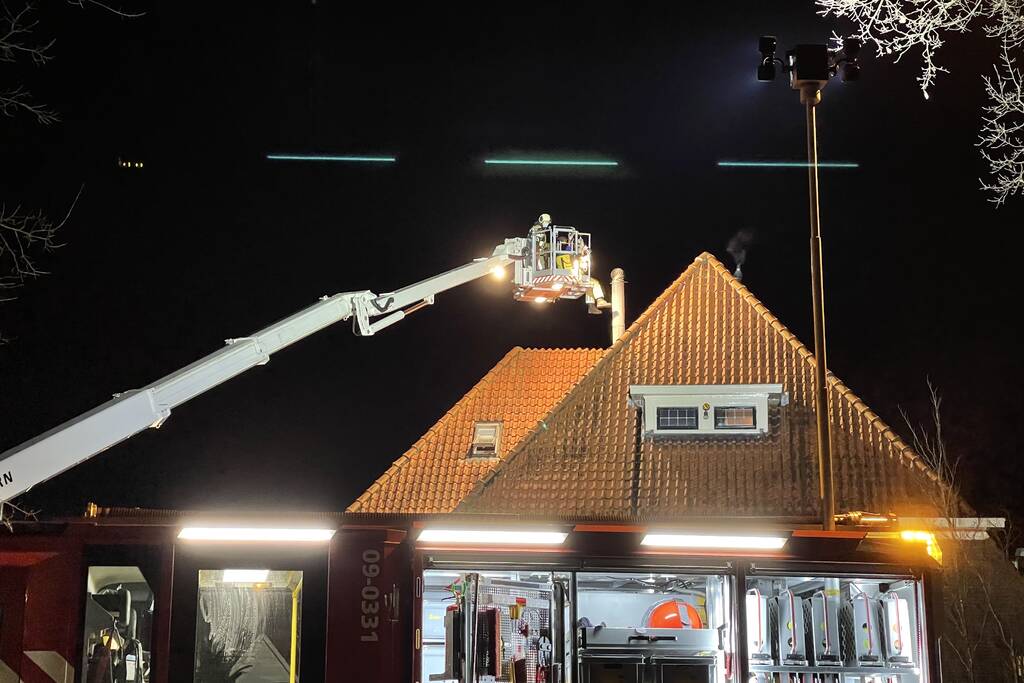 Brandweer blust brand in schoorsteen