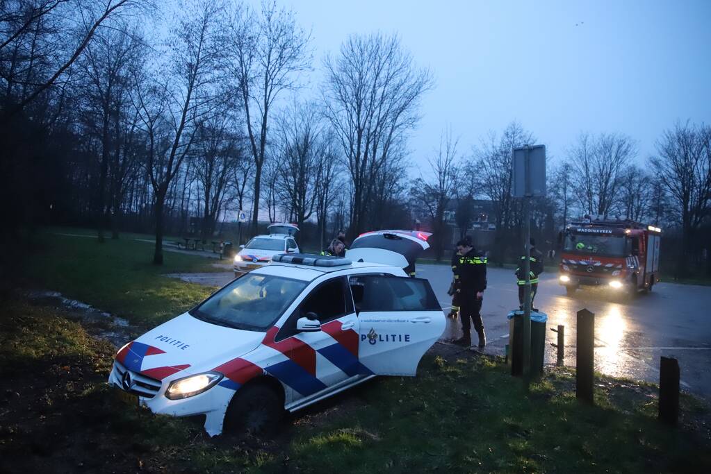Politieauto rijdt zich vast in modder