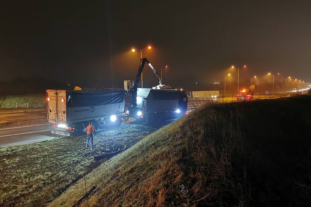 Lading van omgevallen trailer wordt opgeruimd