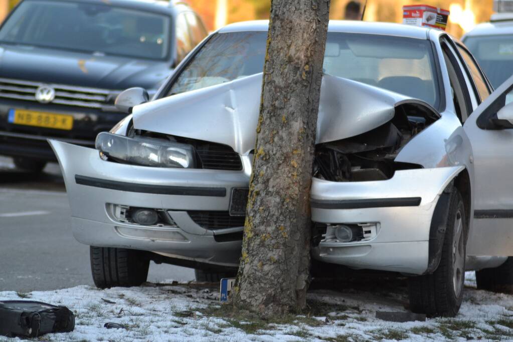 Personenauto klapt tegen boom