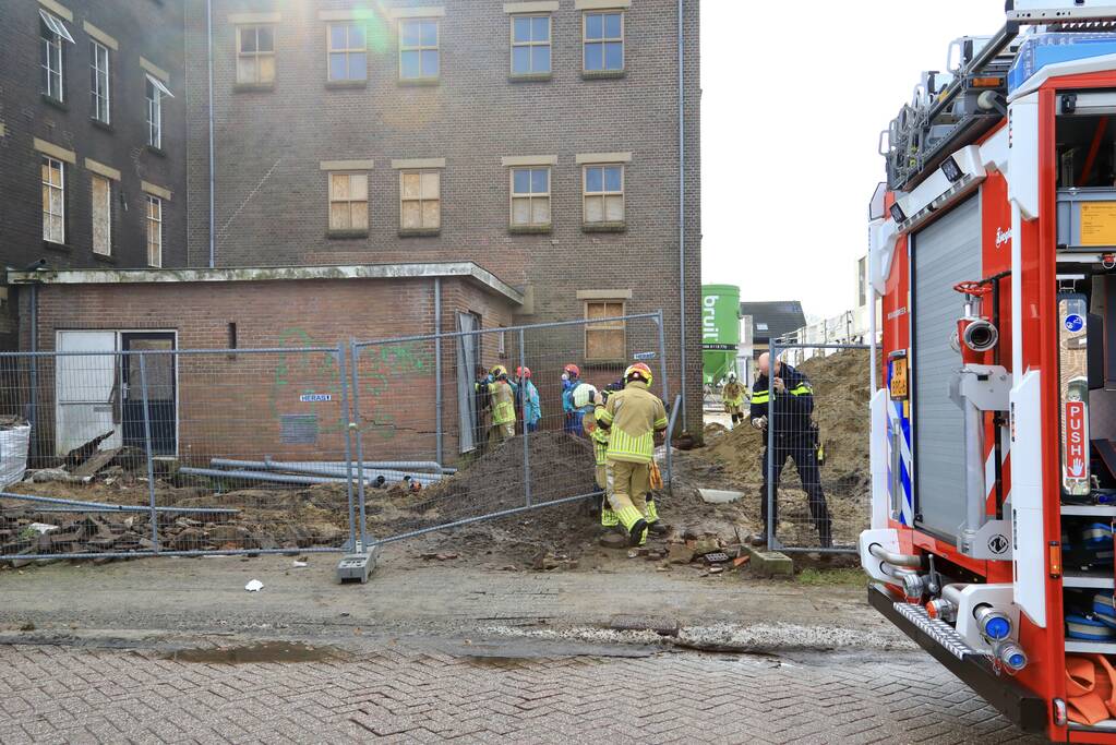 Persoon bekneld onder betonnen plaat