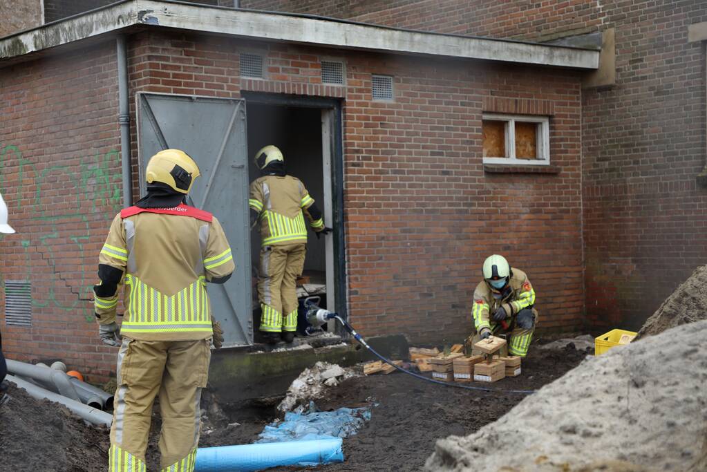 Persoon bekneld onder betonnen plaat