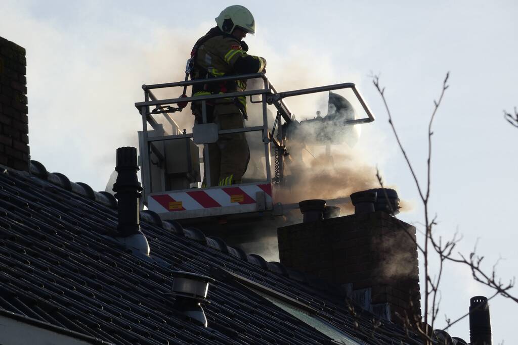 Brandweer veegt schoorsteen na brand