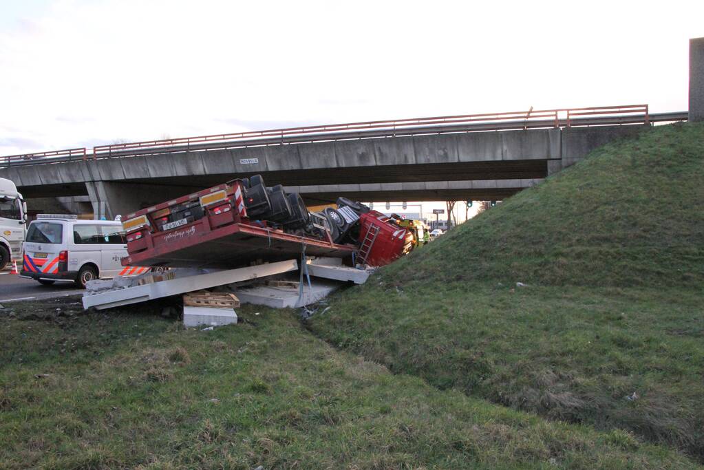 Vrachtwagen met betonplaten belandt op de kop