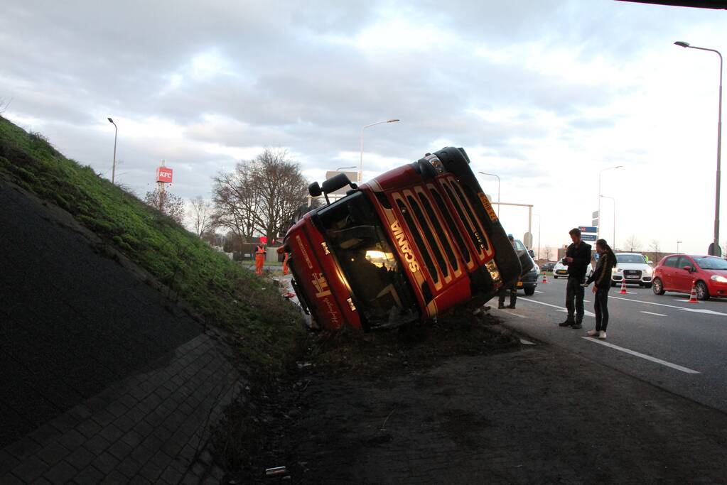 Vrachtwagen met betonplaten belandt op de kop