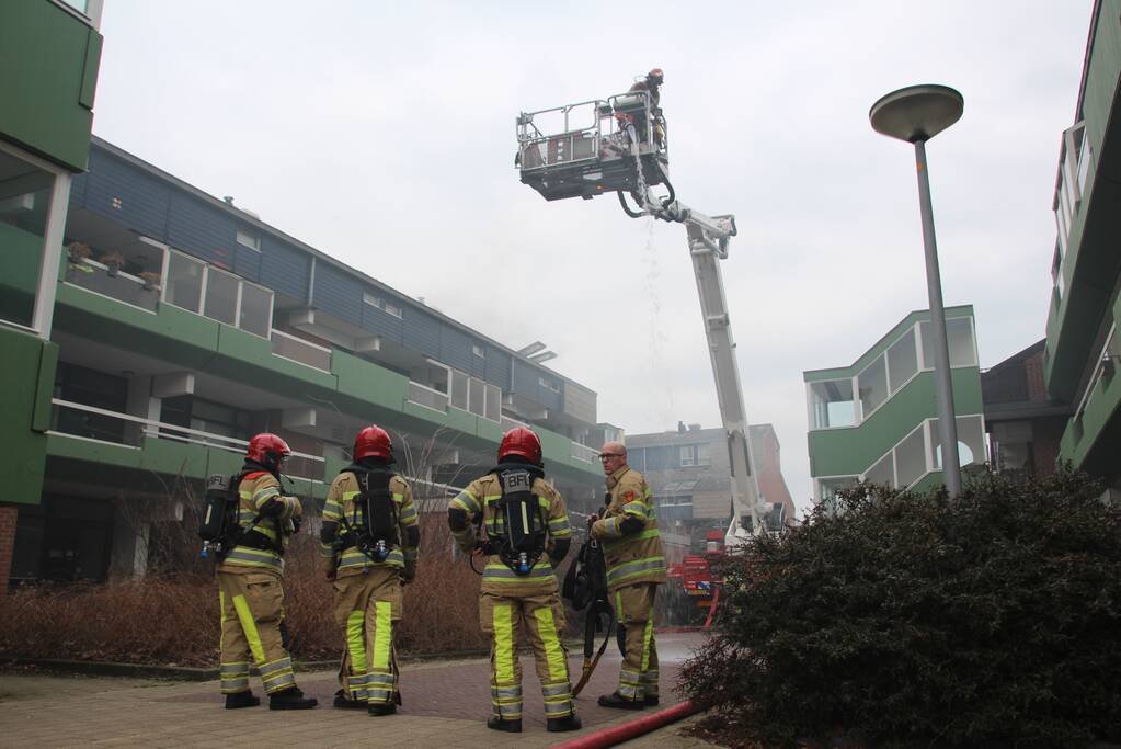 Brandweer blust brandend dak