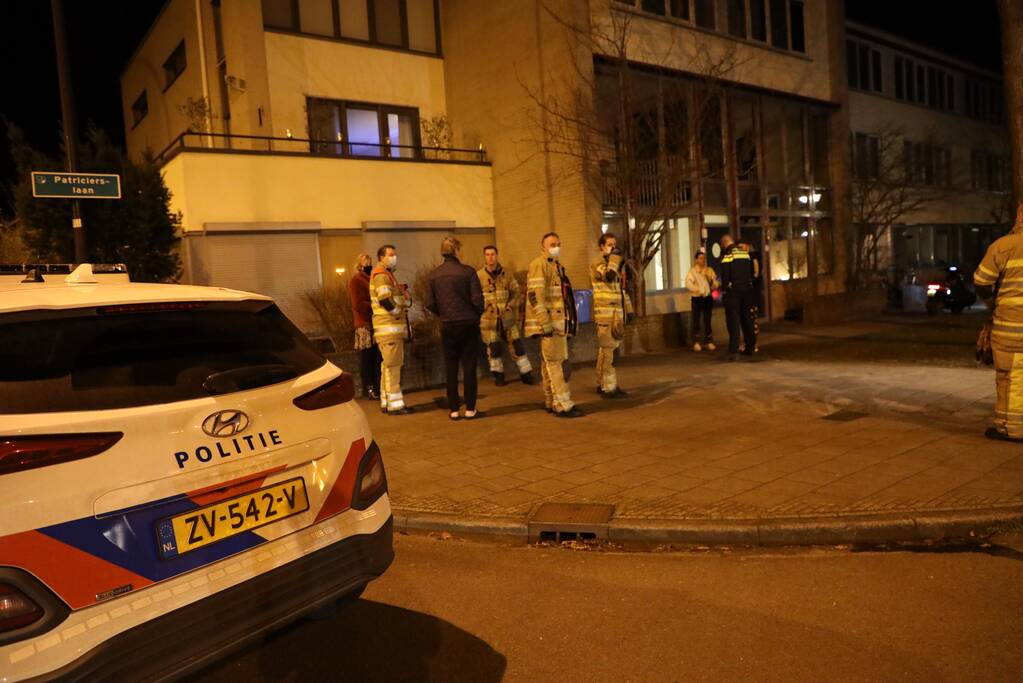 Brandweer blust brandende papiercontainer