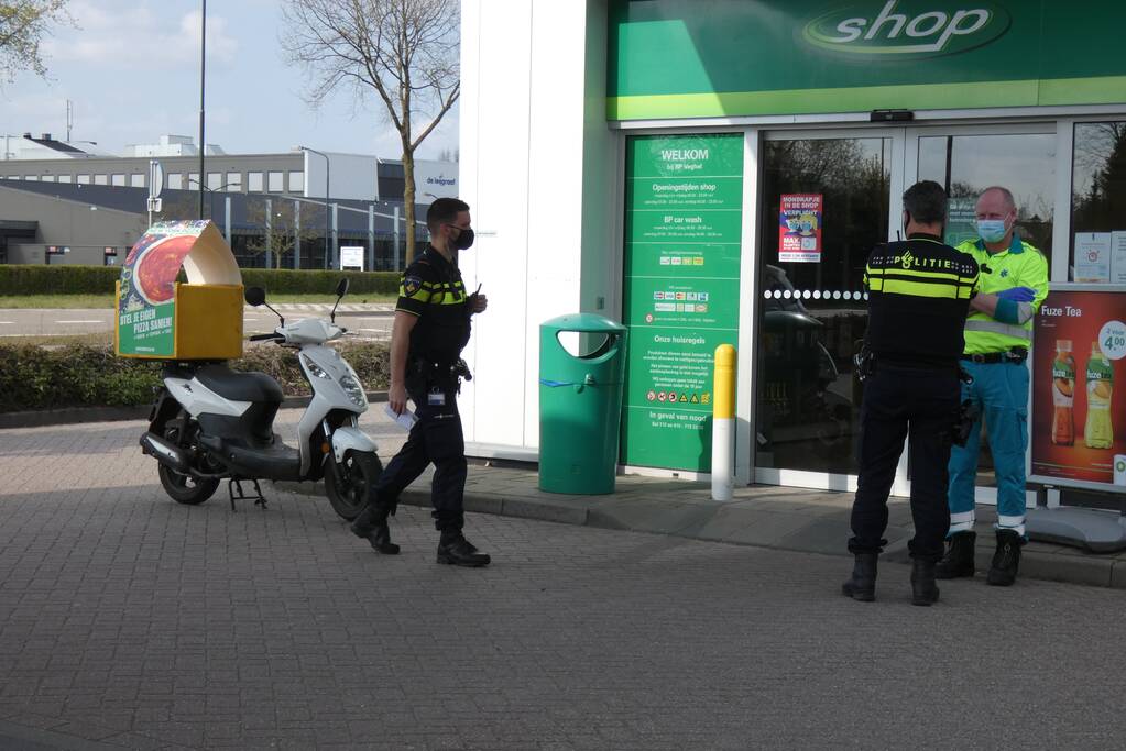 Maaltijdbezorger geholpen door ambulancepersoneel na val