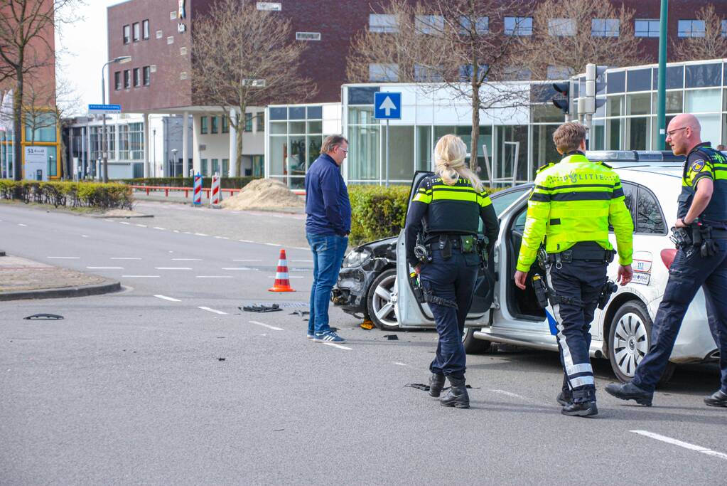 Politieauto met spoed ramt personenauto