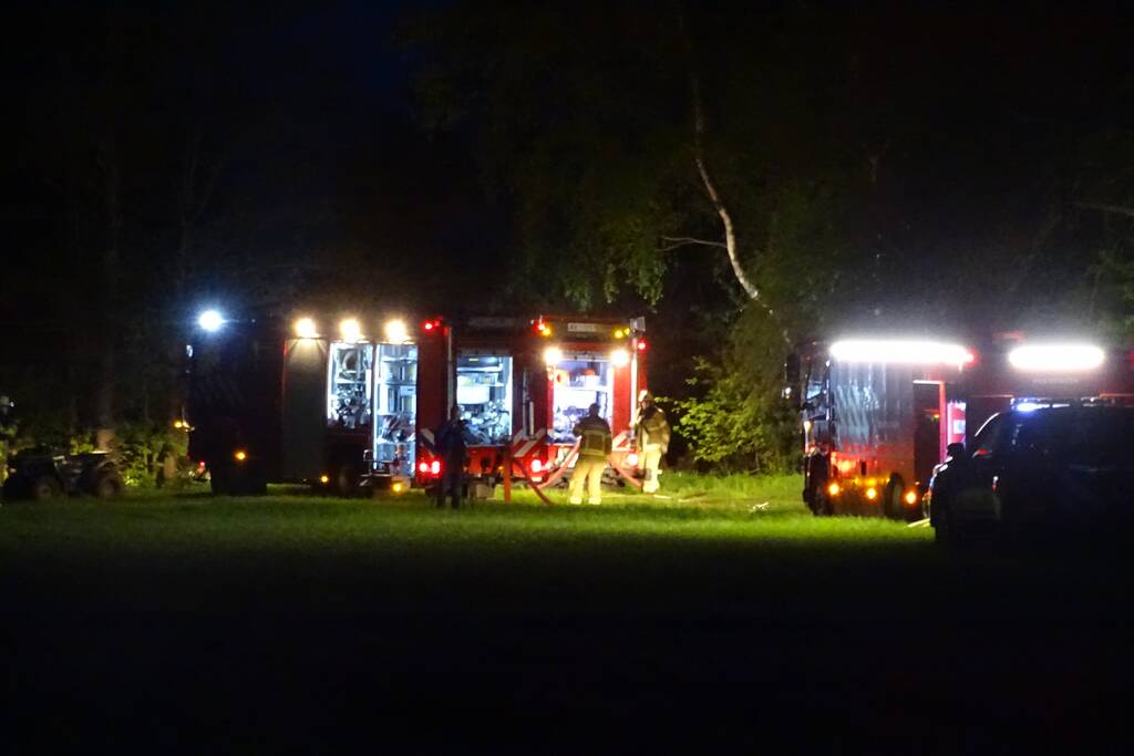 Brand in bos nabij woning