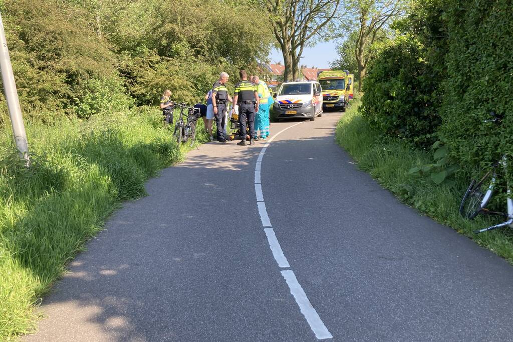 Vrouw gaat met fiets onderuit