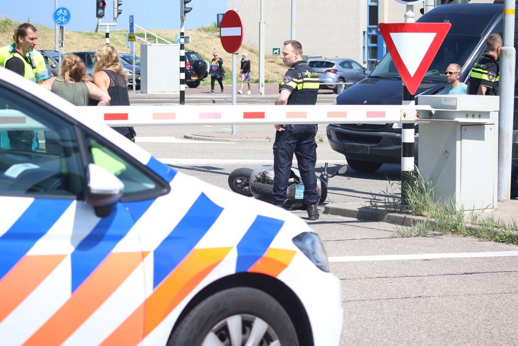 Auto botst op scooter voor ingang veerdienst