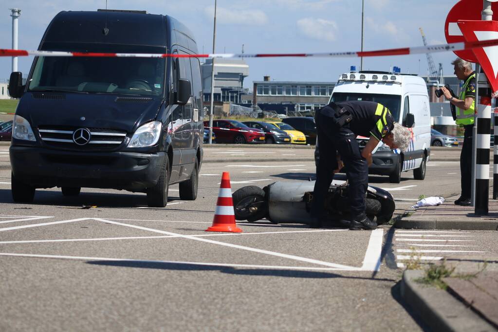 Auto botst op scooter voor ingang veerdienst