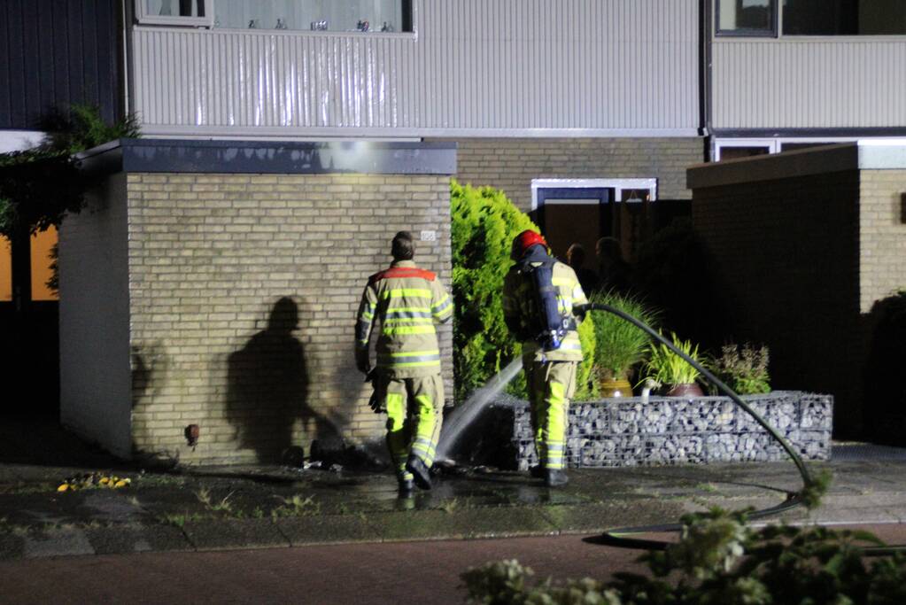 Schade aan muur door brandende papiercontainer