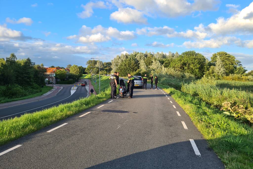 Persoon ten val met scooter