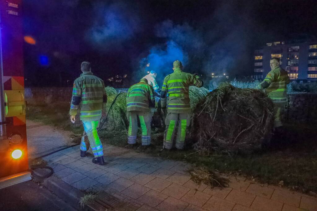 Broeiende hooibalen uit elkaar gehaald