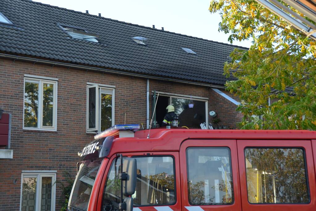Brandweer blust brand in pan op het vuur