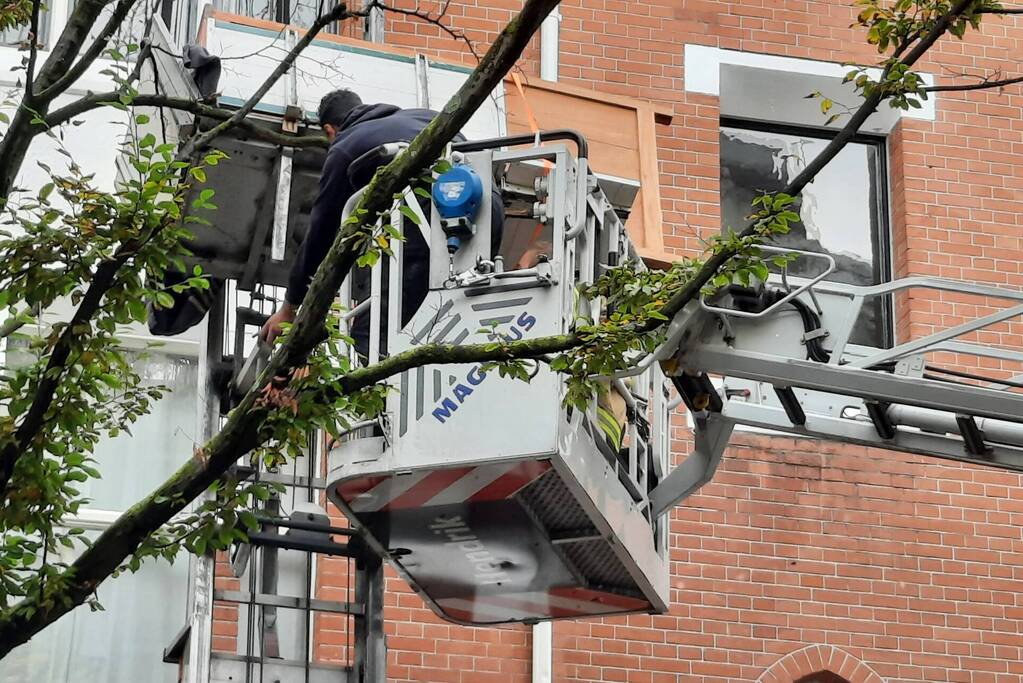 Verhuislift raakt vast in takken van boom