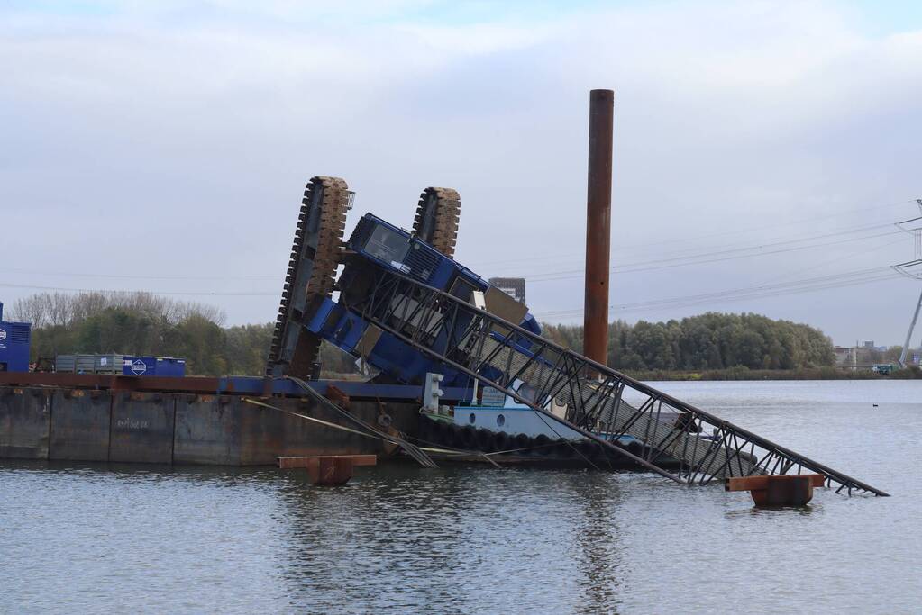 Hijskraan op ponton valt in water