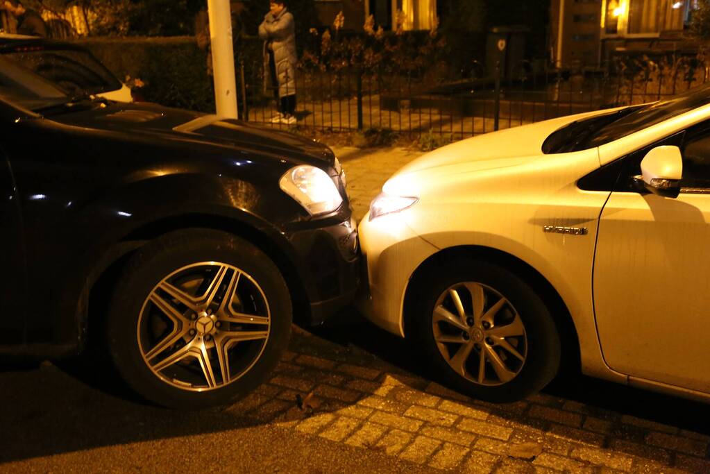 Automobilist krijgt lekke band en botst op geparkeerde auto's