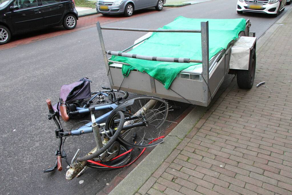 Aanhanger schiet los van auto en schept fietser