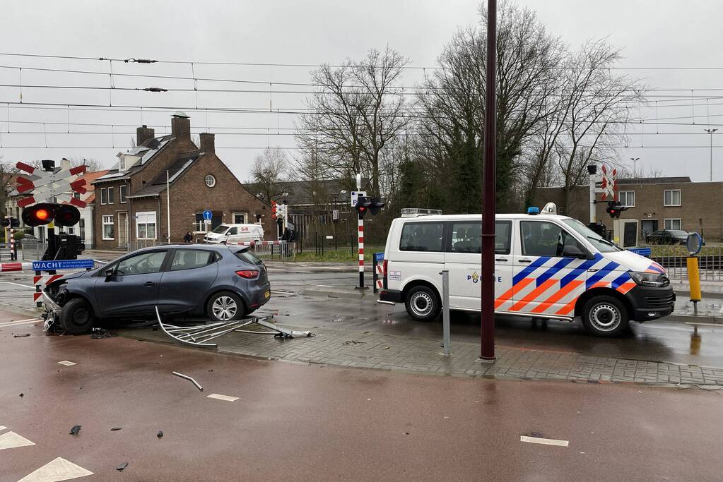 Automobilist rijdt door hekwerk bij spoorwegovergang NS-station