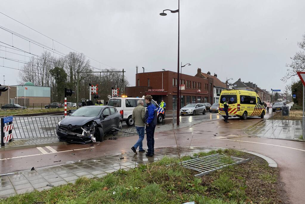 Automobilist rijdt door hekwerk bij spoorwegovergang NS-station