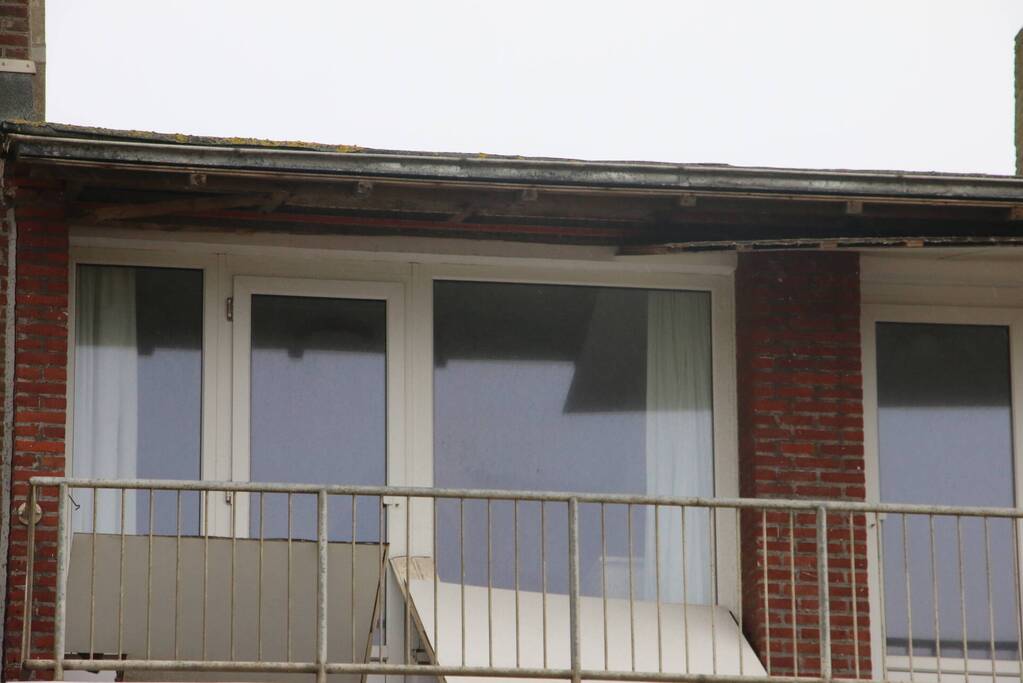 Brandweer verwijderd dakplaten en zet dakgoot vast