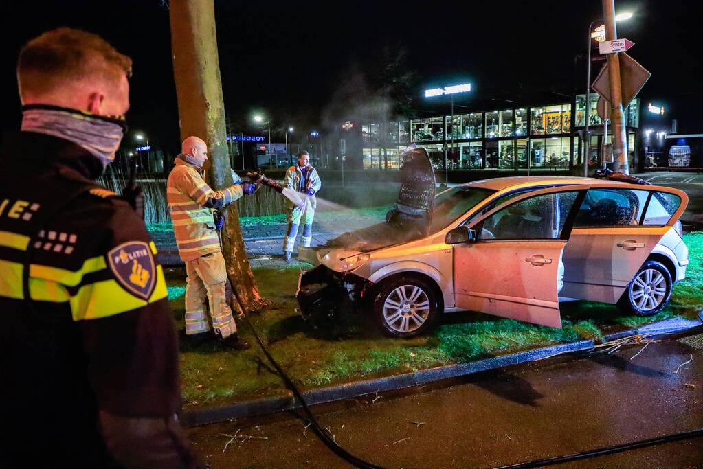 Auto vliegt in brand na botsing tegen boom