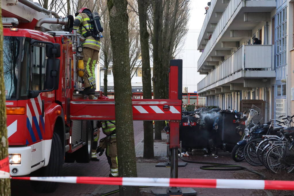 Containers vliegen in brand in flatgebouw