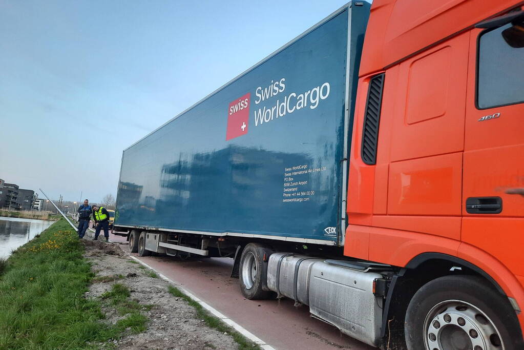 Vrachtwagen rijdt zich vast in berm
