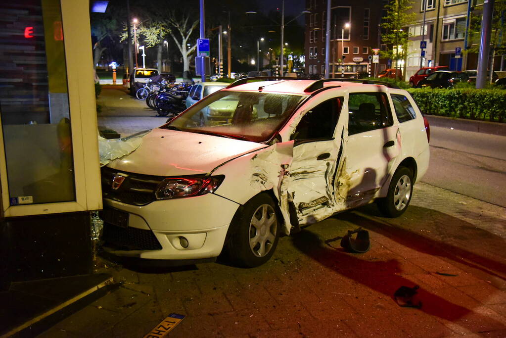 Auto knalt tegen winkelpand door botsing