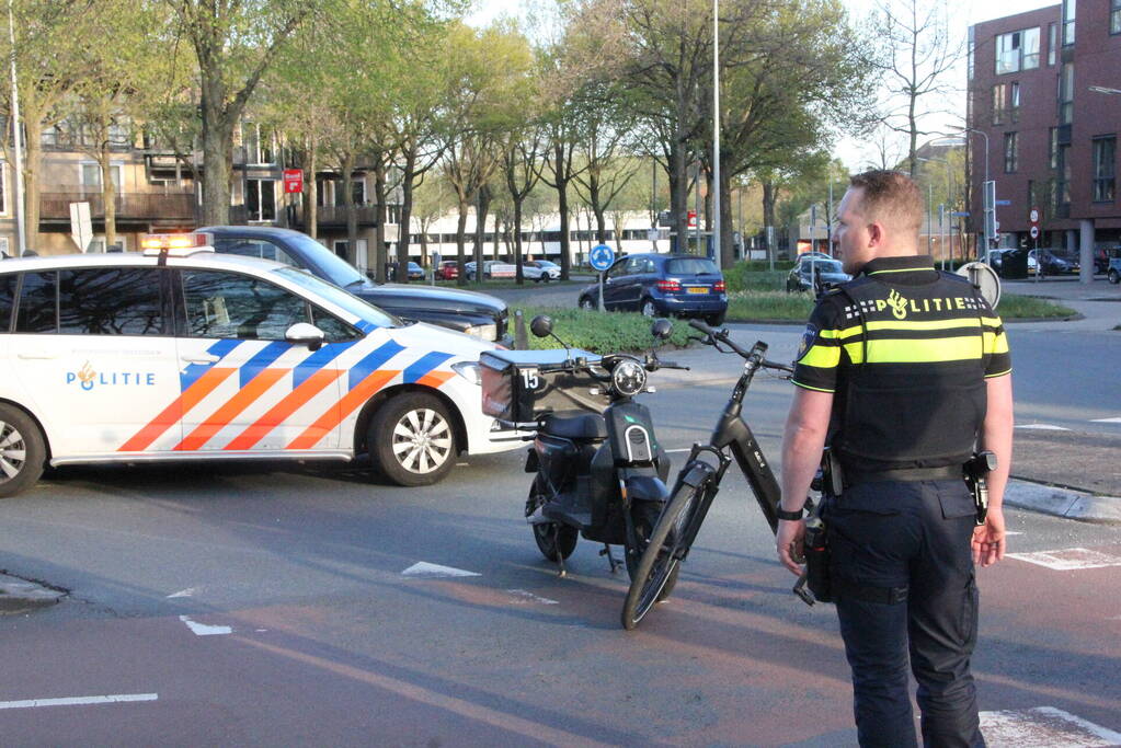 Fietser en scooterrijder botsen bij rotonde