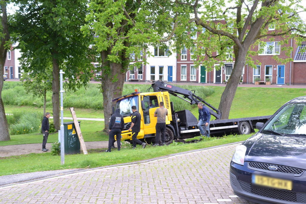 Vrachtwagen zakt weg in berm