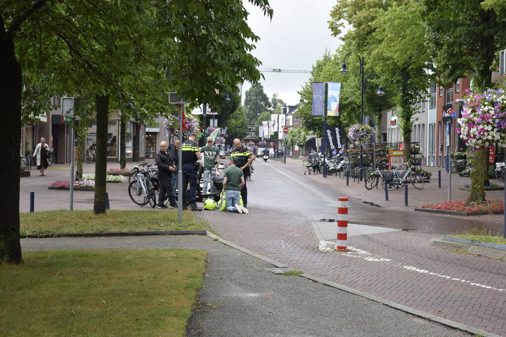 Persoon met bezorgscooter ten val