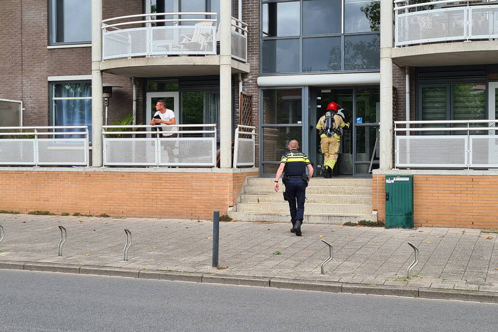 Zwarte rook uit appartement vanwege brand