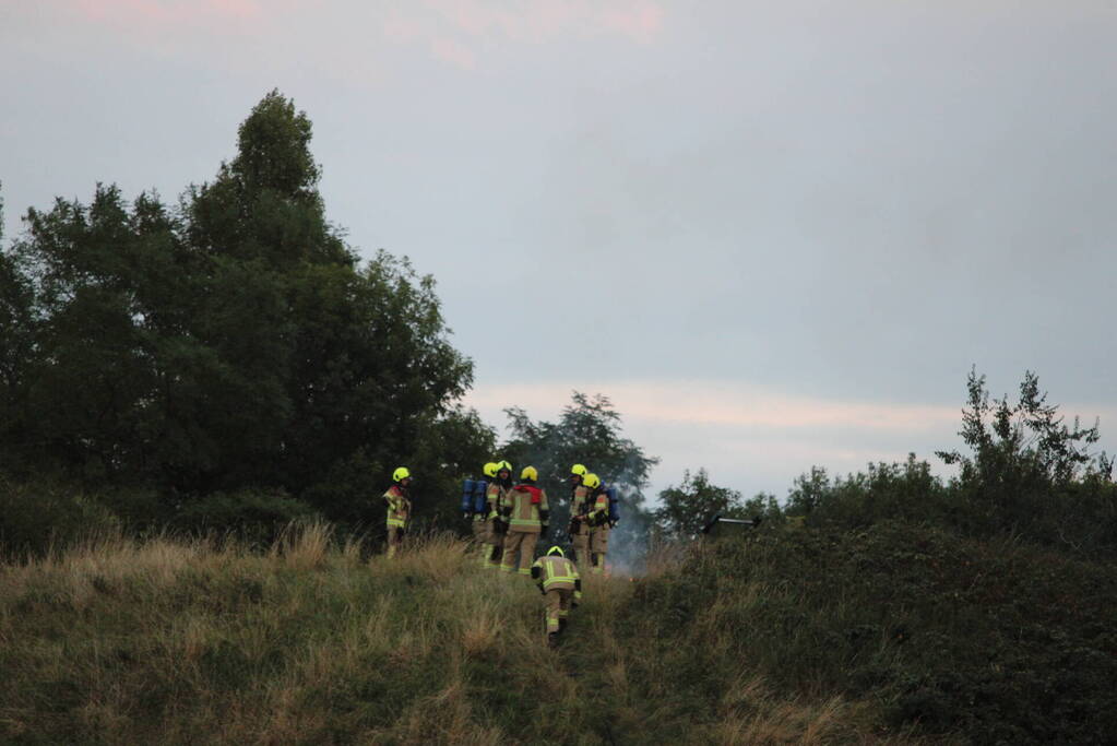 Pallets boven op berg in brand gevlogen