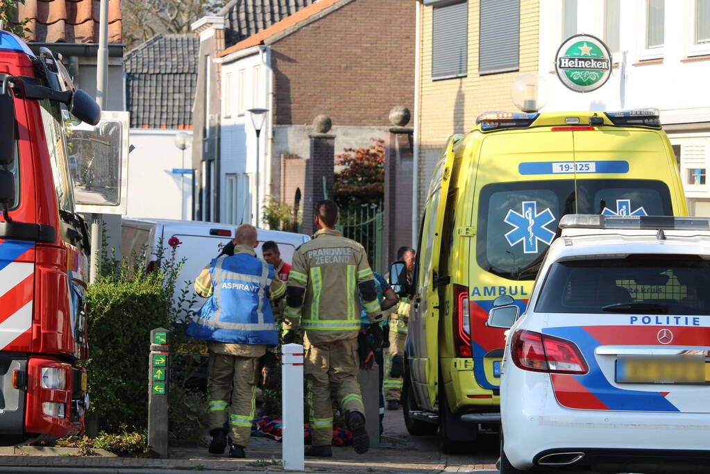 Persoon komt onder bestelbus terecht