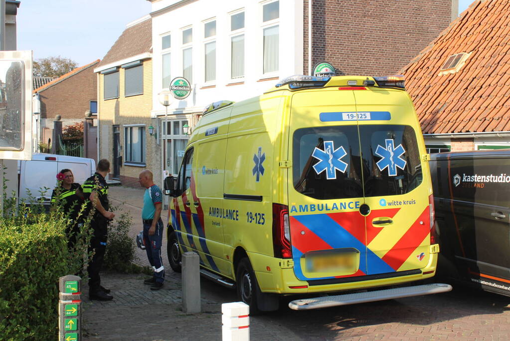 Persoon komt onder bestelbus terecht