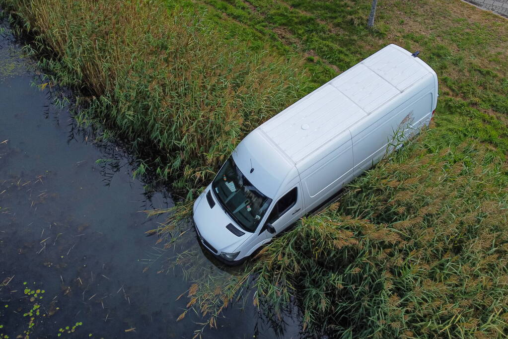 Bestelbus van pakketbezorger rolt water in