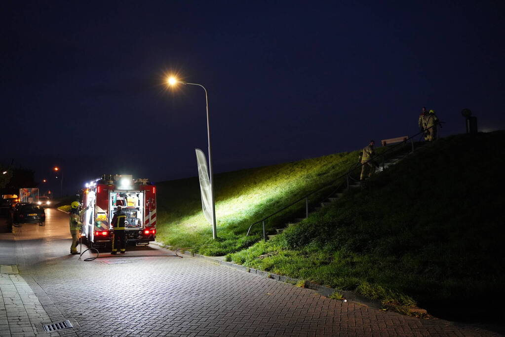 Brandweer blust in brand gestoken prullenbak
