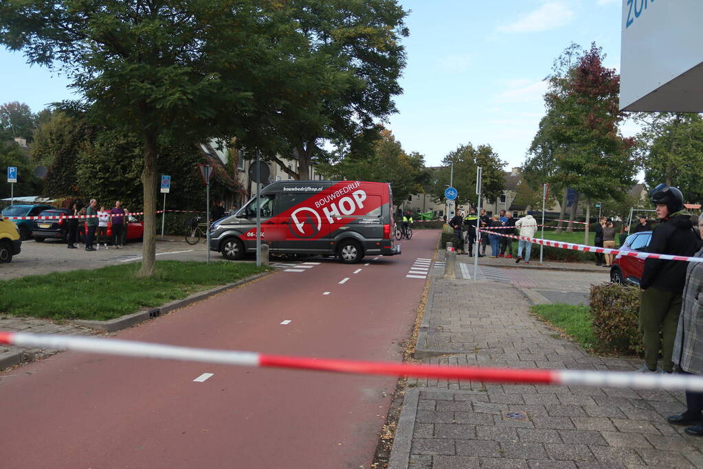 Persoon belandt onder bestelbus