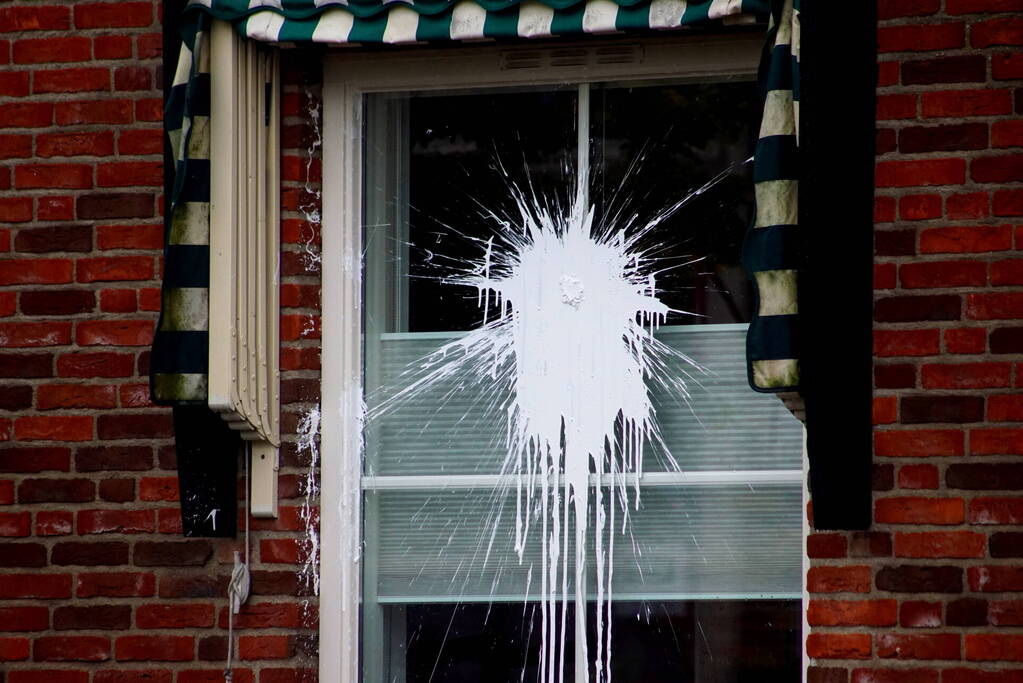 Verfbom tegen raam gegooid