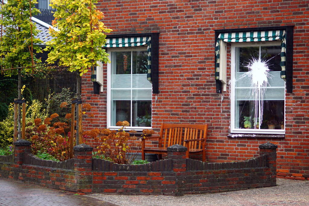 Verfbom tegen raam gegooid