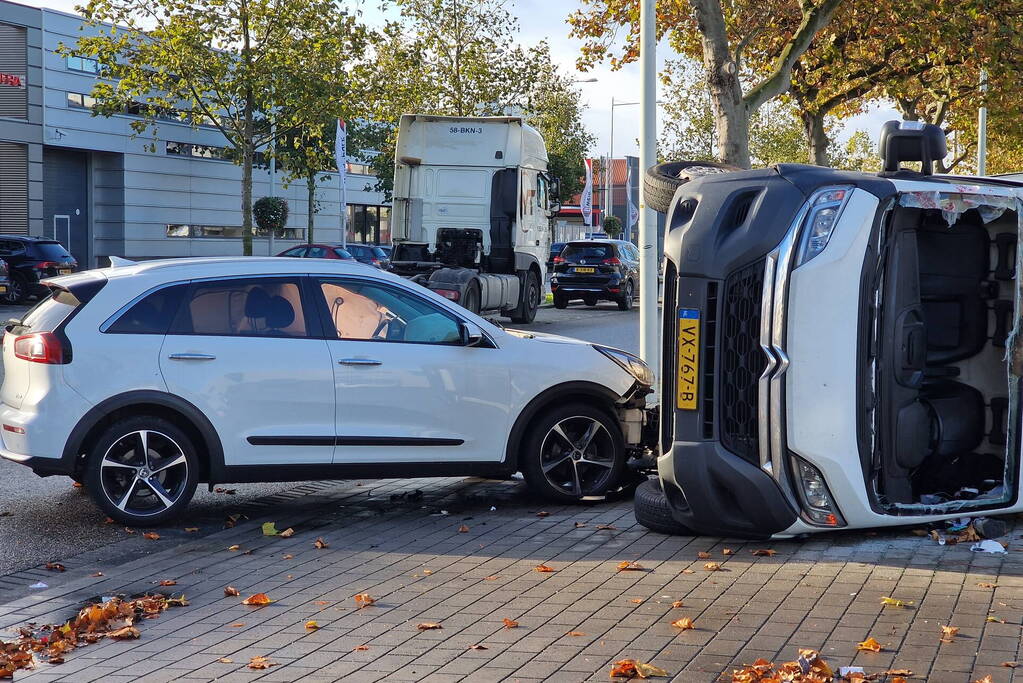 Bestelbus belandt op zijn kant bij botsing met auto