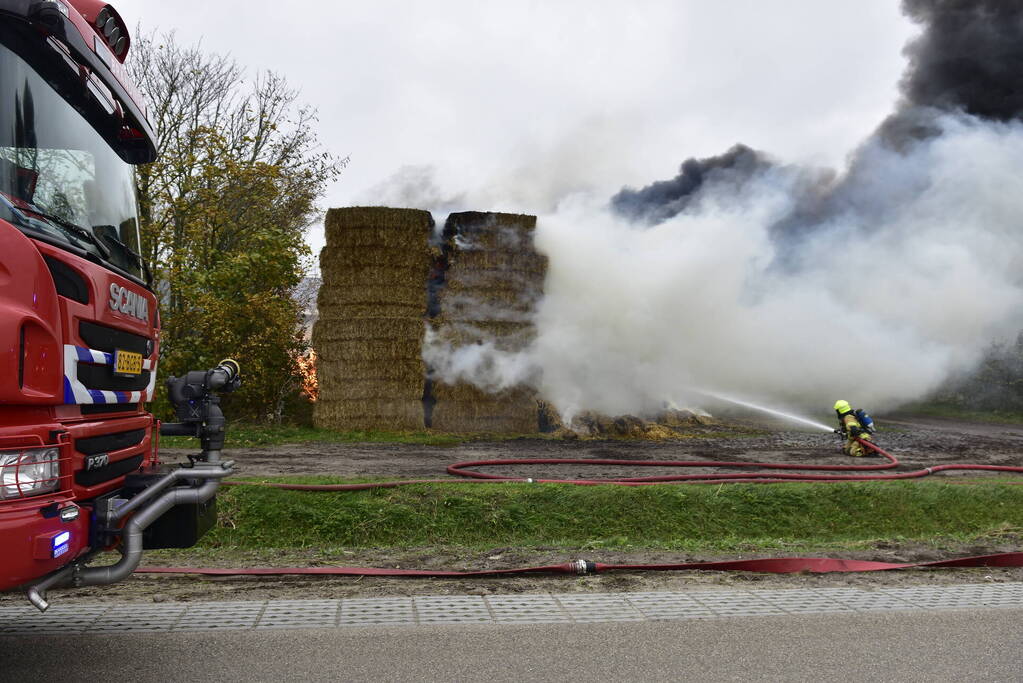 Grote stapel hooi vliegt in brand