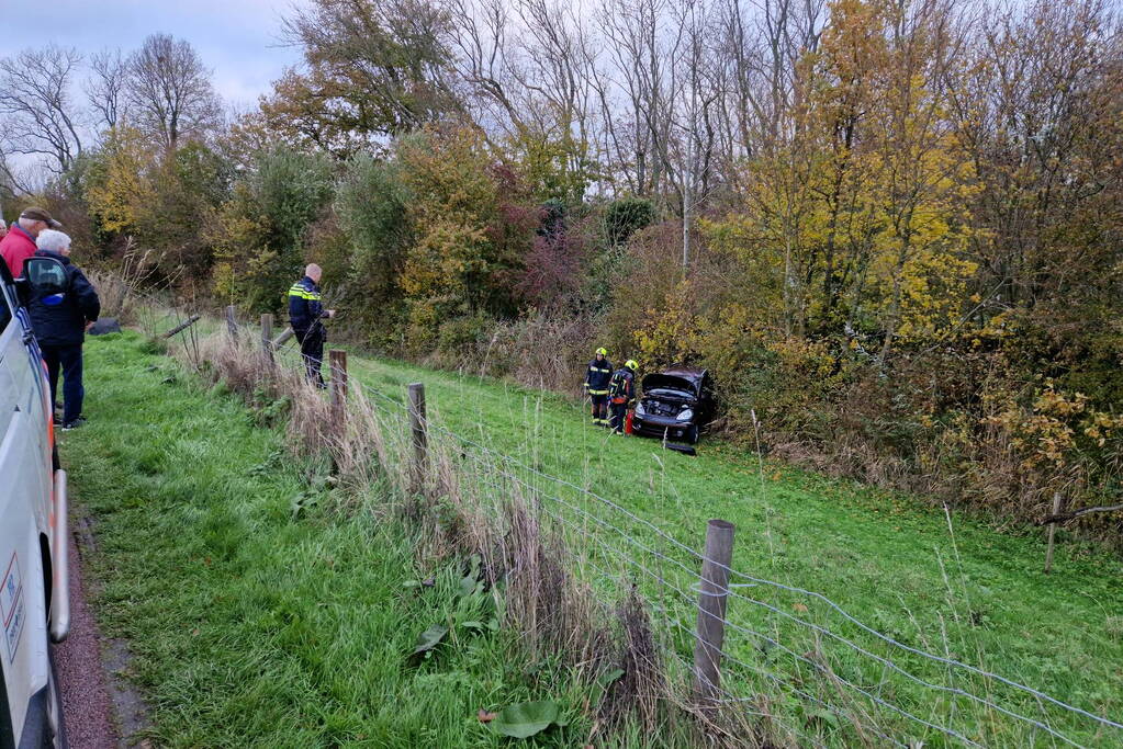 Auto rolt van de dijk af